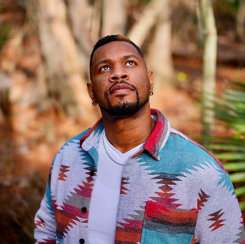 Black male singer performing on stage under spotlight; independent artist recording vocals in studio; emotional live performance; musician playing keyboard in church setting.